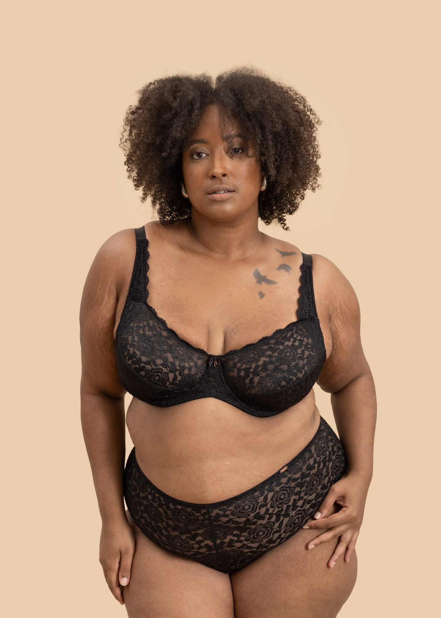 Plus-size black floral lace lingerie set with a supportive full-coverage underwire bra and matching high-waisted panties.