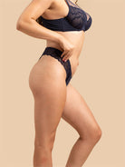 Side view of the Black SHADOW Velvet Thong showing the slim, minimal coverage fit.