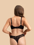Back view of the SHADOW Black Mesh Bralette showing hook-and-eye closure and thong detail.