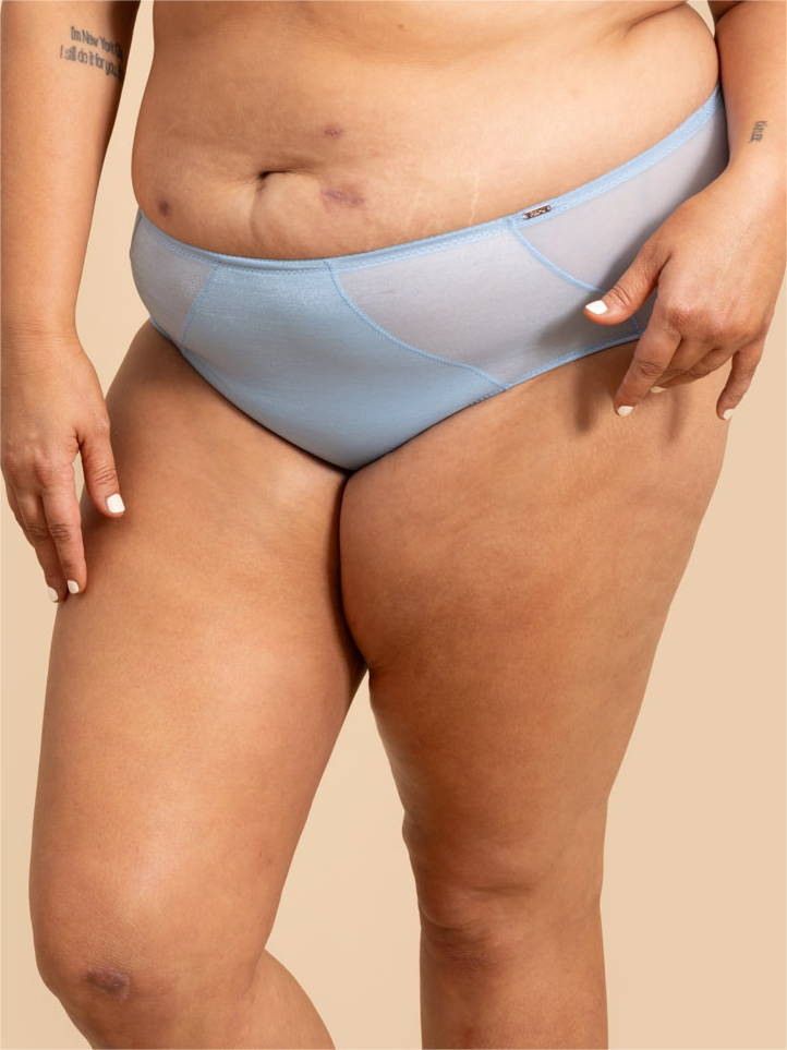 Light blue underwear worn by a person on a beige background