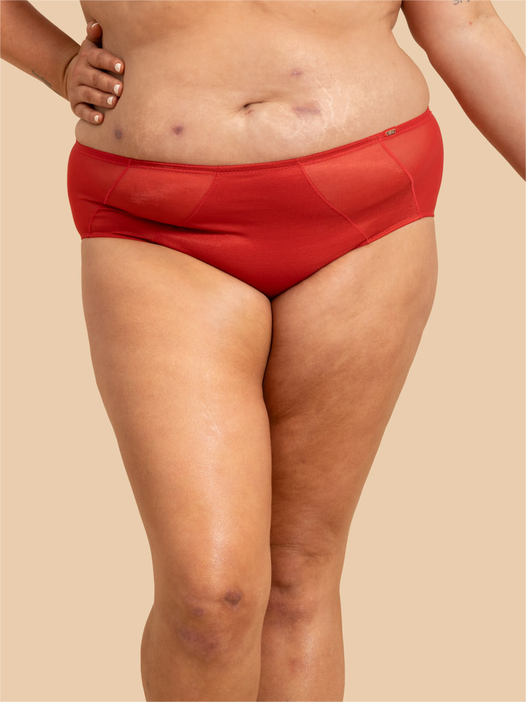 Person wearing red underwear on a beige background