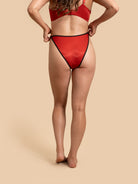 Person wearing a red bikini on a beige background