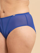 Blue underwear worn by a person on a beige background
