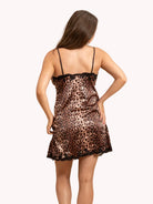 Woman wearing a leopard print nightgown on a beige background