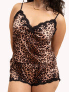 Leopard print lingerie set with lace trim on a beige background